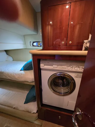  Yacht Photos Pics Interior of 2002 Sea Ray 560 Sedan Bridge with washer and cozy bunk beds.