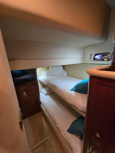  Yacht Photos Pics Interior of 2002 Sea Ray 560 Sedan Bridge with cozy bunk beds.