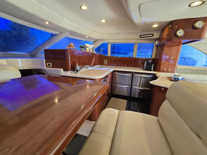  Yacht Photos Pics Luxurious interior of 2002 Sea Ray 560 Sedan Bridge yacht with elegant wood finishes.