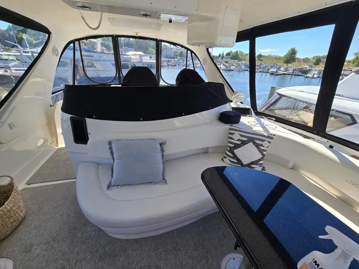  Yacht Photos Pics Interior of 2002 Sea Ray 560 Sedan Bridge yacht with plush seating and scenic marina view.