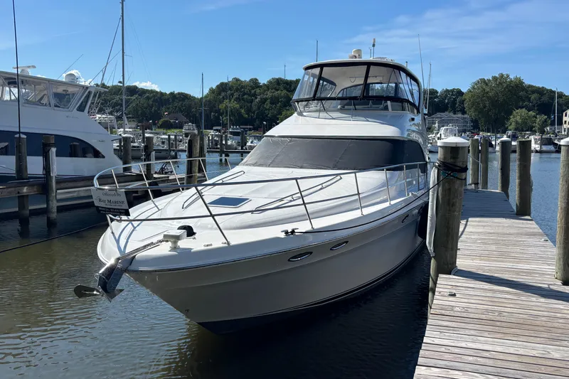  Yacht Photos Pics 2002 Sea Ray 560 Sedan Bridge yacht docked at a marina on a sunny day.