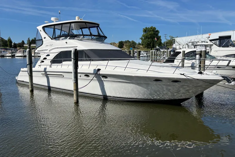  Yacht Photos Pics 2002 Sea Ray 560 Sedan Bridge yacht docked in a marina under clear blue skies.