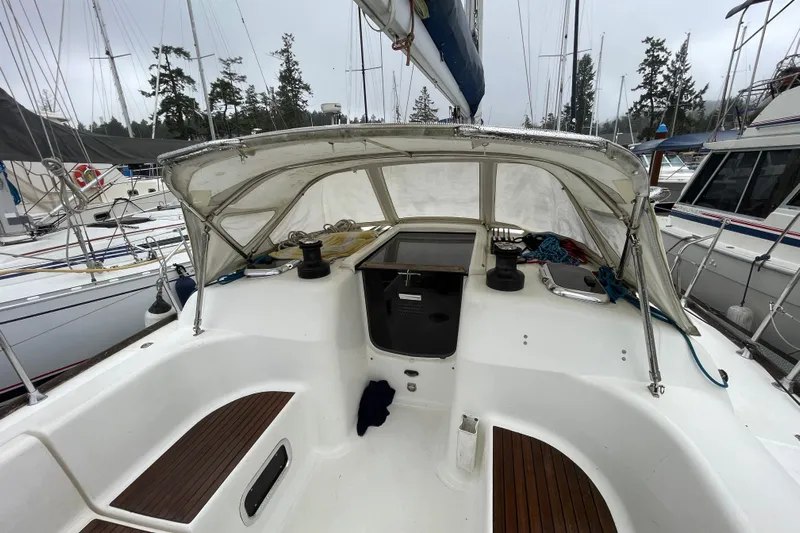 New Journey Yacht Photos Pics 2005 Dufour 40 Performance sailboat cockpit with canopy, docked in a marina.