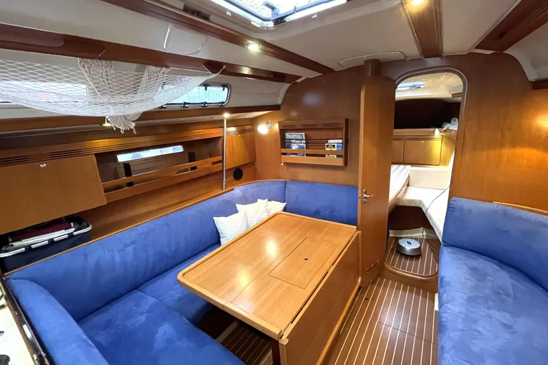 New Journey Yacht Photos Pics Interior of 2005 Dufour 40 Performance yacht with blue seating and wooden finishes.