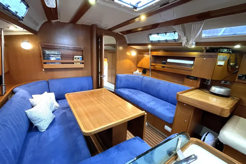 New Journey Yacht Photos Pics Luxurious interior of 2005 Dufour 40 Performance yacht with blue seating and wooden finishes.