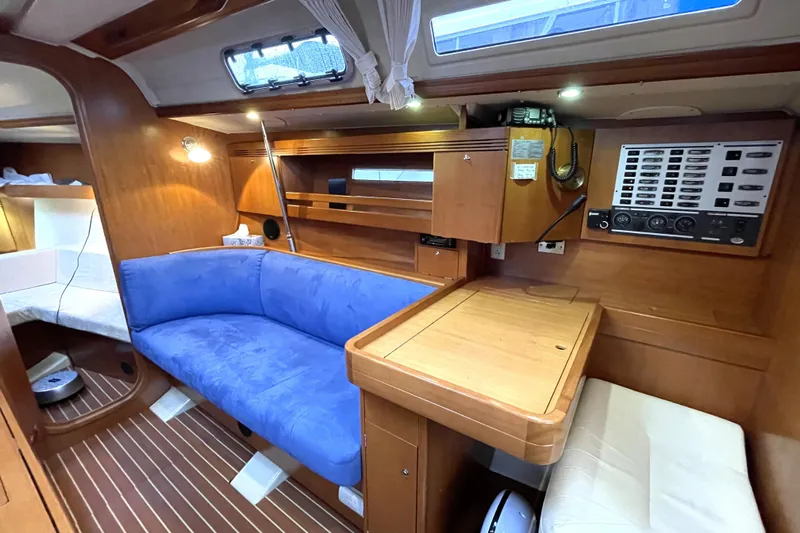 New Journey Yacht Photos Pics Interior of 2005 Dufour 40 Performance yacht with blue seating and wooden finishes.