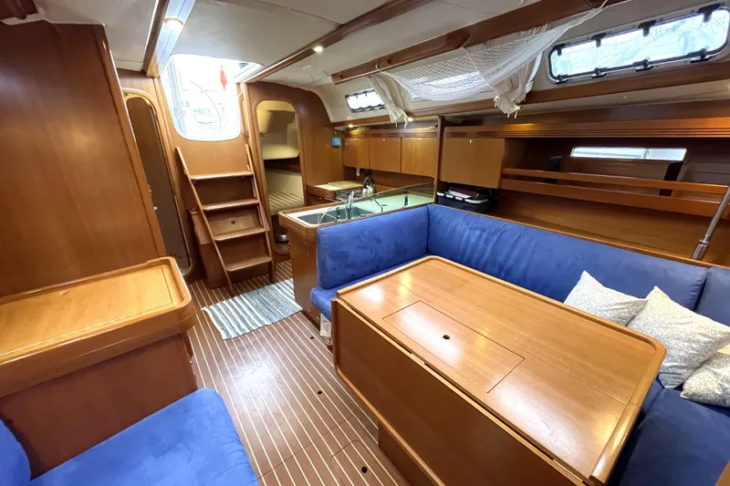 New Journey Yacht Photos Pics Interior of 2005 Dufour 40 Performance yacht with wooden finish and blue seating.