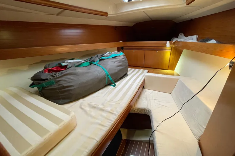 New Journey Yacht Photos Pics Cozy cabin interior of 2005 Dufour 40 Performance sailboat with striped bedding.
