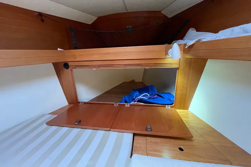 New Journey Yacht Photos Pics Cozy cabin interior of 2005 Dufour 40 Performance yacht with wooden storage compartments.