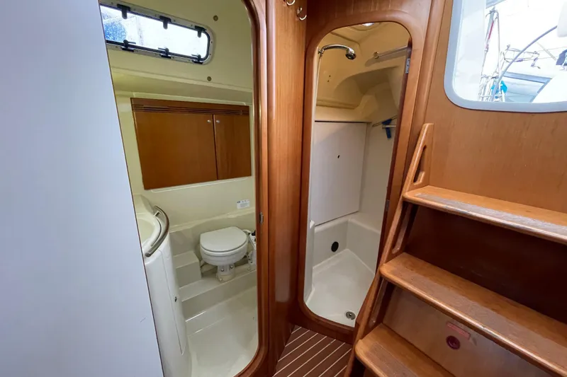 New Journey Yacht Photos Pics Interior of 2005 Dufour 40 Performance yacht, featuring bathroom and wooden stairs.