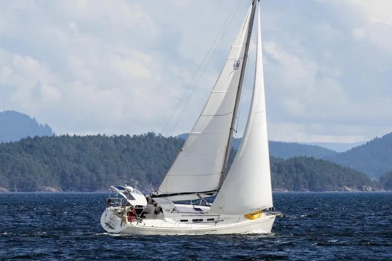 New Journey Yacht Photos Pics Sailing yacht Dufour 40 Performance 2005 on open water with forested hills in background.
