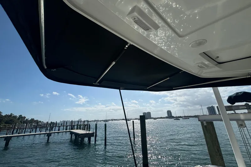 1095-953 Brokerage Josh Yacht Photos Pics 2024 Jeanneau NC Weekender 1095 Fly, docked with scenic waterfront view.