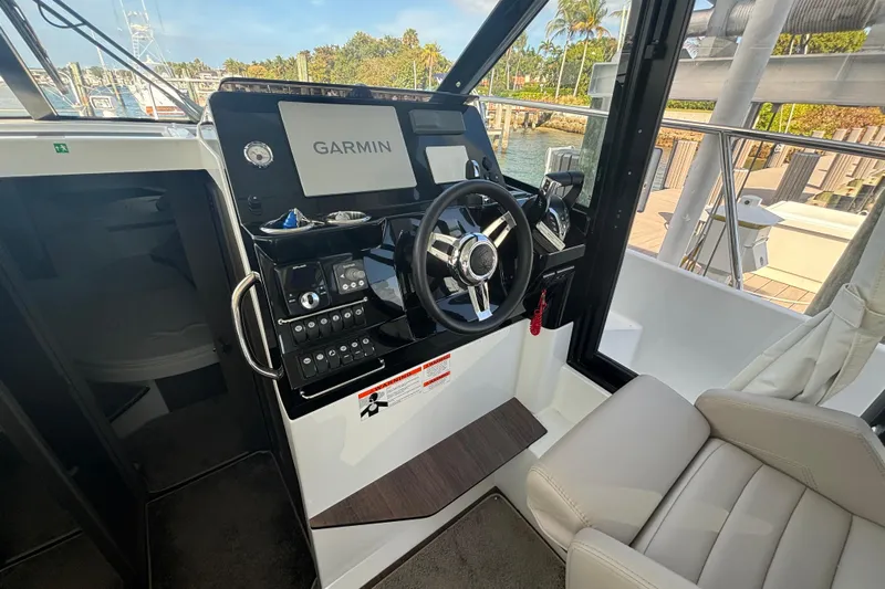 1095-953 Brokerage Josh Yacht Photos Pics 2024 Jeanneau NC Weekender 1095 Fly helm with Garmin navigation system.