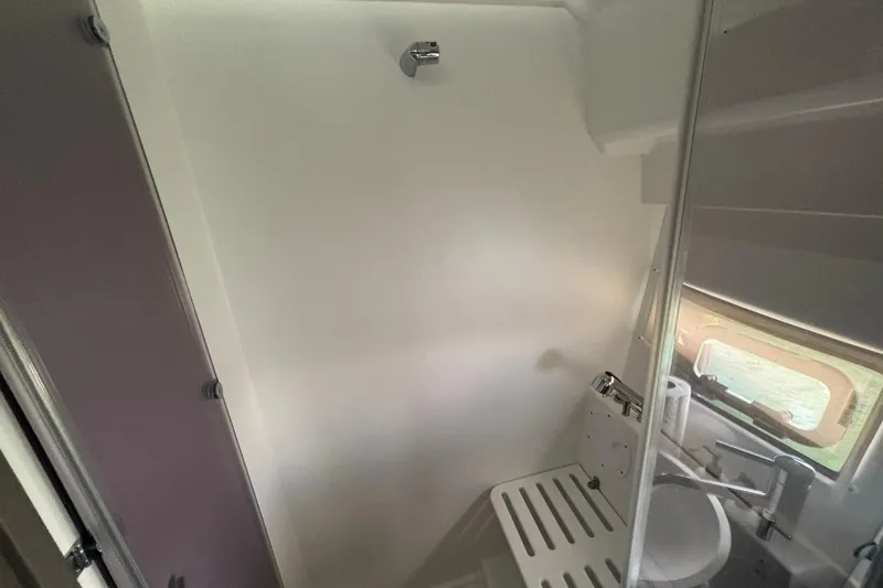 1095-953 Brokerage Josh Yacht Photos Pics 2024 Jeanneau NC Weekender 1095 Fly bathroom with modern fixtures and window.