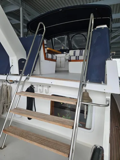 Kolea Yacht Photos Pics 1983 Ocean Alexander 43 yacht with ladder and covered seating area.