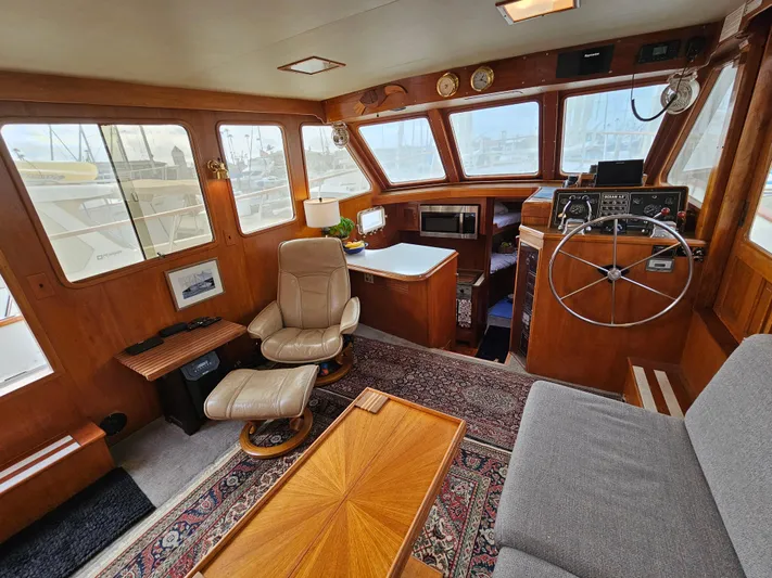 Kolea Yacht Photos Pics Interior of 1983 Ocean Alexander 43 yacht with wooden decor and comfortable seating.