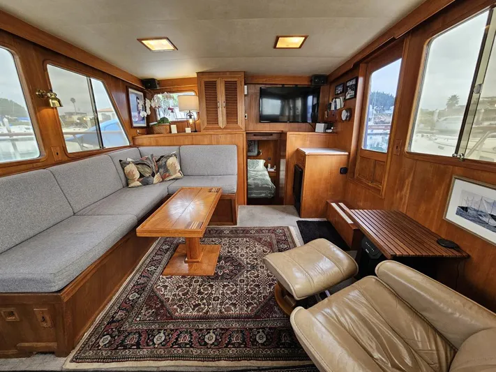 Kolea Yacht Photos Pics Interior of 1983 Ocean Alexander 43 yacht with cozy seating and elegant wood finishes.