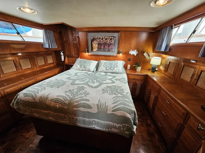 Kolea Yacht Photos Pics Luxurious 1983 Ocean Alexander 43 yacht bedroom with wood paneling and elegant bedding.