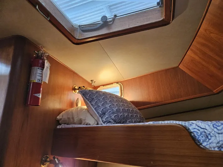 Kolea Yacht Photos Pics Cozy cabin interior of 1983 Ocean Alexander 43 yacht with wooden bunk and porthole.