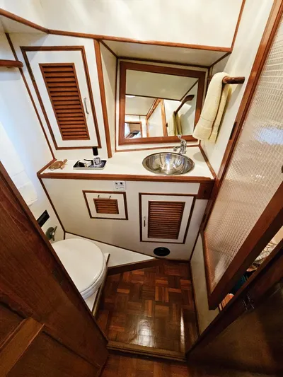 Kolea Yacht Photos Pics 1983 Ocean Alexander 43 yacht bathroom with wood accents and compact design.