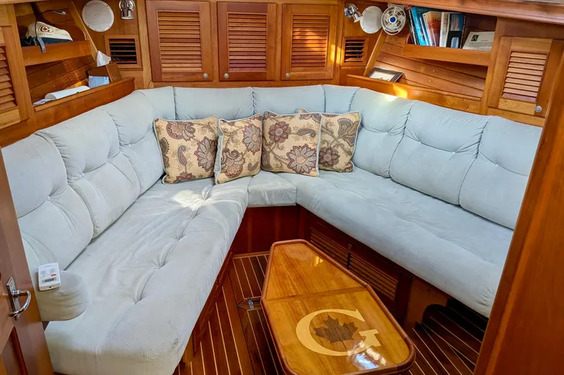  Yacht Photos Pics Luxurious interior of 2003 Gozzard 37 sailboat with plush seating and wooden accents.