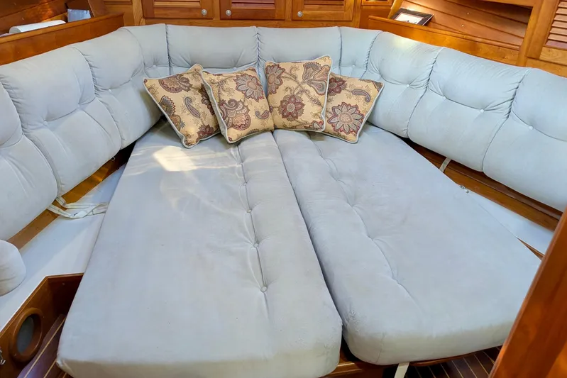  Yacht Photos Pics Luxurious interior of 2003 Gozzard 37 sailboat with plush seating and decorative pillows.