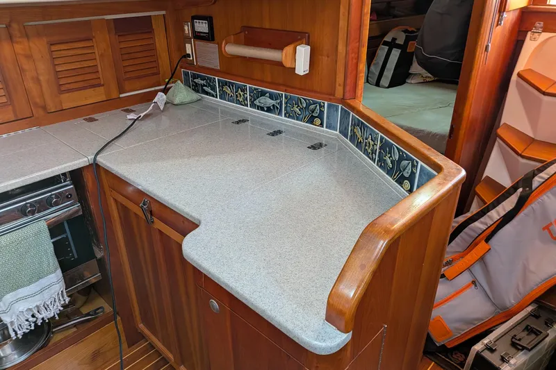 Yacht Photos Pics 2003 Gozzard 37 yacht interior with wooden cabinetry and tiled countertop.