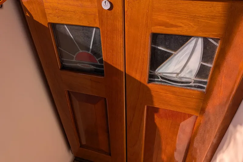  Yacht Photos Pics Wooden door with stained glass panels featuring a sailboat and sunset, Gozzard 37, 2003.