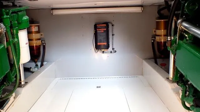 Proud Lady Yacht Photos Pics 1957 Rybovich Convertible engine room with mechanical components and lighting.