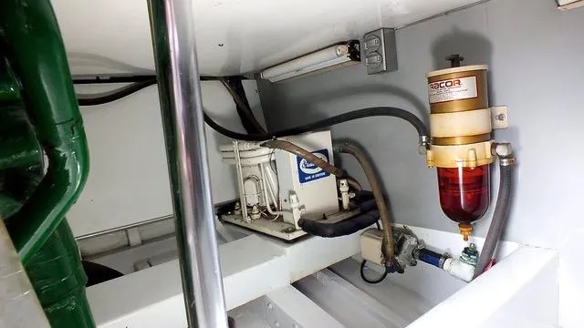 Proud Lady Yacht Photos Pics 1957 Rybovich Convertible engine room with fuel filter and mechanical components.