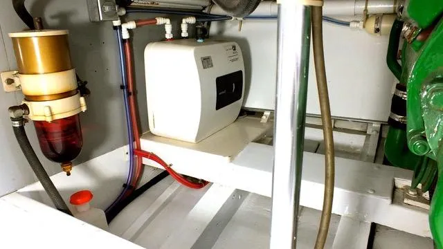 Proud Lady Yacht Photos Pics Engine room of a 1957 Rybovich Convertible boat, showcasing mechanical components and wiring.