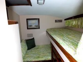 Proud Lady Yacht Photos Pics 1957 Rybovich Convertible cabin with bunk beds and nautical decor.