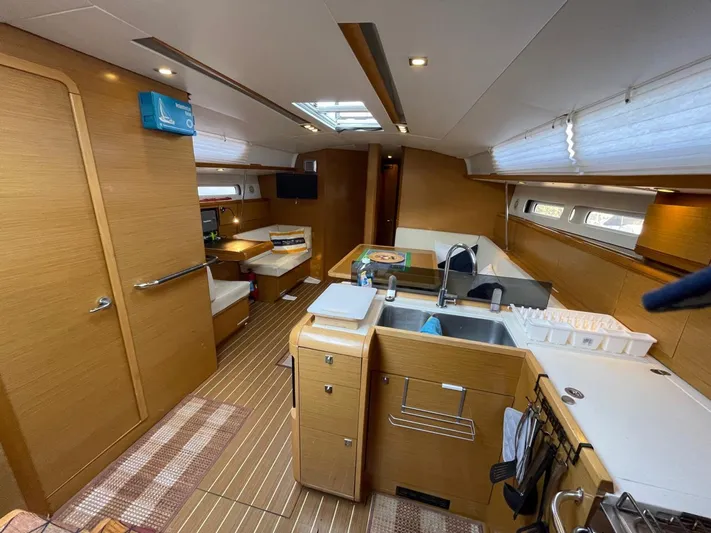  Yacht Photos Pics Interior of 2011 Jeanneau Sun Odyssey 439 yacht, featuring modern kitchen and seating area.