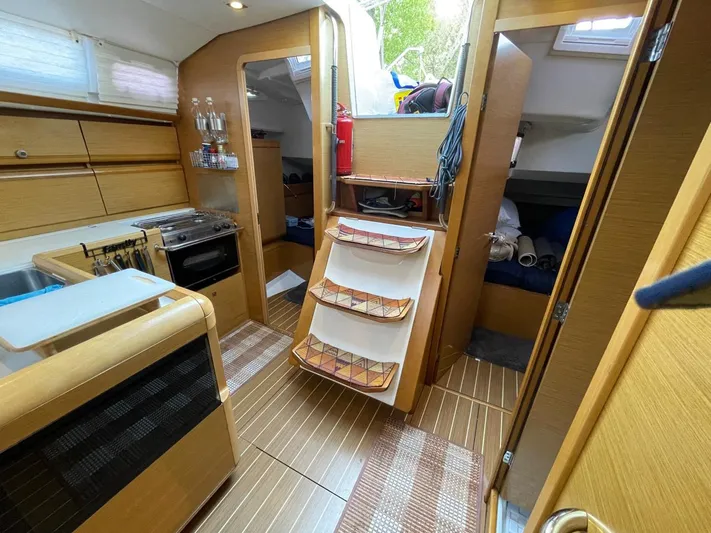  Yacht Photos Pics Interior of 2011 Jeanneau Sun Odyssey 439 sailboat with kitchen and cozy cabin spaces.