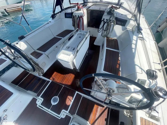 Yacht Photos Pics 2011 Jeanneau Sun Odyssey 439 sailboat cockpit with dual steering wheels and teak flooring.