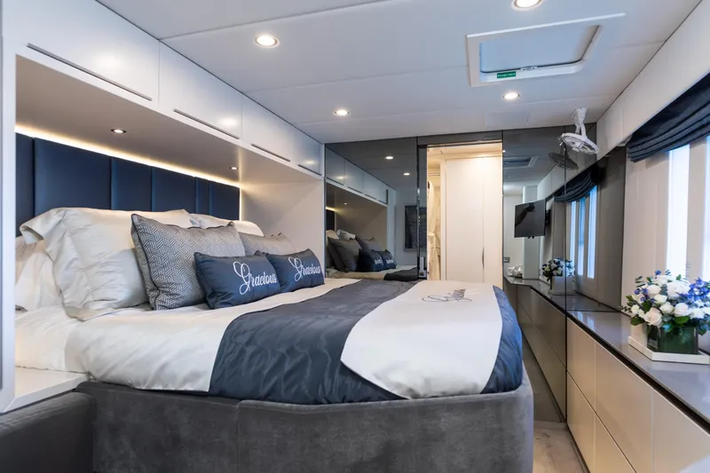 Gracious Yacht Photos Pics Luxurious Sunreef 60 yacht bedroom interior, featuring elegant bedding and modern decor, 2021 model.