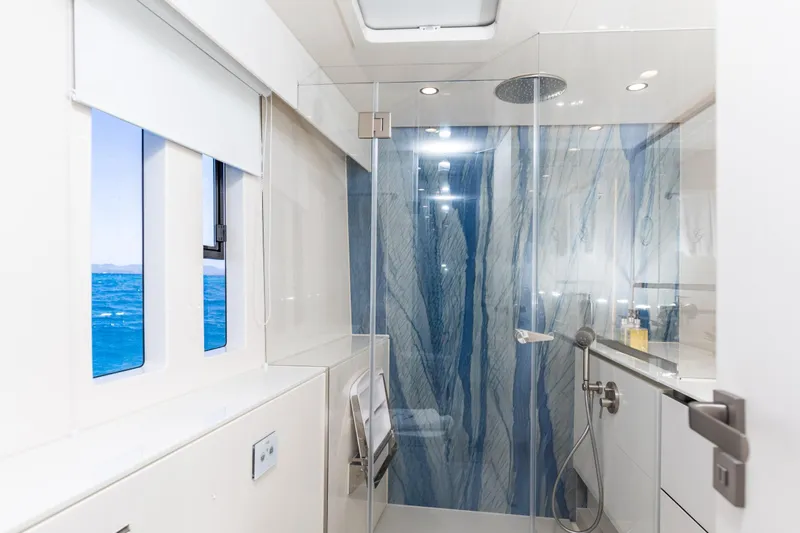 Gracious Yacht Photos Pics Luxurious bathroom on 2021 Sunreef 60 yacht with ocean view and modern shower design.