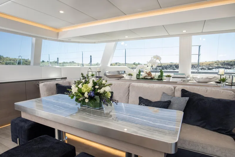 Gracious Yacht Photos Pics Luxurious interior of 2021 Sunreef 60 yacht with elegant dining area and scenic views.