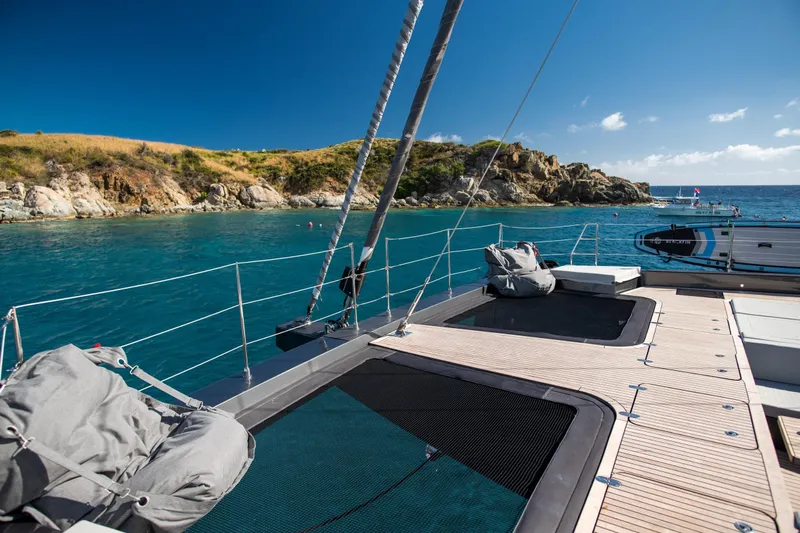 Gracious Yacht Photos Pics Luxurious 2021 Sunreef 60 yacht deck with scenic coastal view.