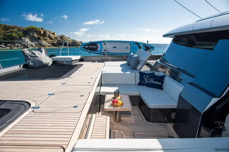 Gracious Yacht Photos Pics Luxurious Sunreef 60 yacht deck with seating, table, and scenic ocean view, 2021 model.