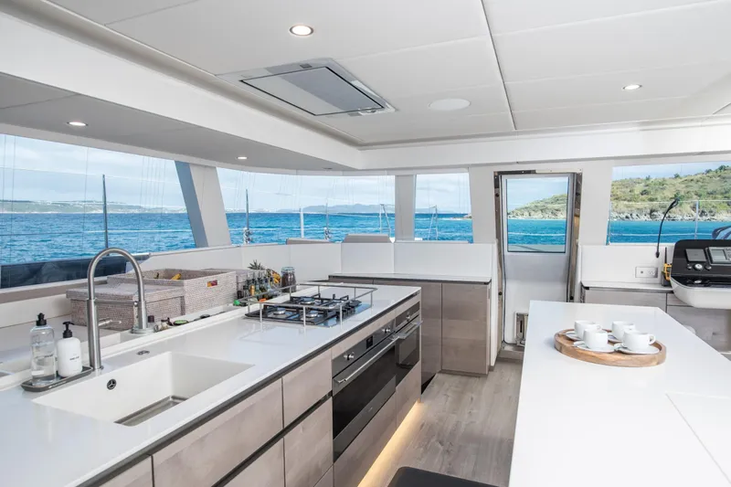 Gracious Yacht Photos Pics Luxurious Sunreef 60 yacht kitchen interior with ocean view, featuring modern appliances and sleek design.