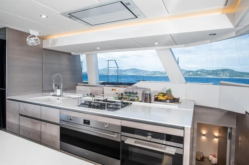 Gracious Yacht Photos Pics Luxurious Sunreef 60 yacht kitchen interior with modern appliances and ocean view, 2021 model.