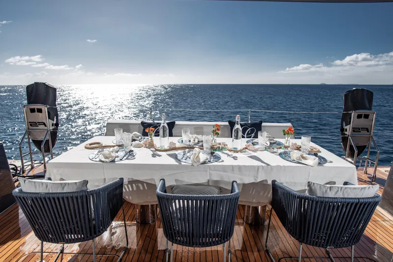 Gracious Yacht Photos Pics Luxurious dining setup on Sunreef 60 yacht, 2021, overlooking serene ocean view.
