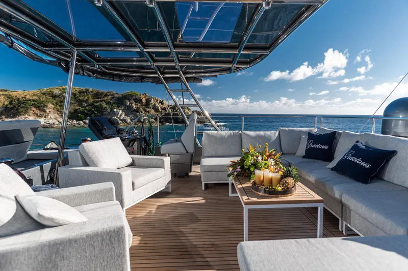 Gracious Yacht Photos Pics Luxurious Sunreef 60 yacht deck with elegant seating, ocean view, and tropical decor, 2021 model.