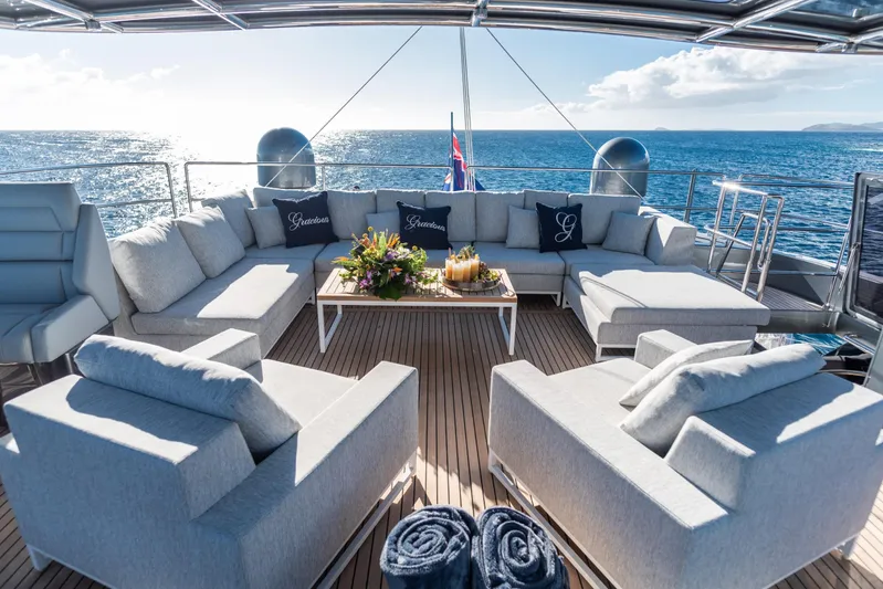 Gracious Yacht Photos Pics Luxurious Sunreef 60 yacht deck with elegant seating, ocean view, and decorative pillows, 2021 model.