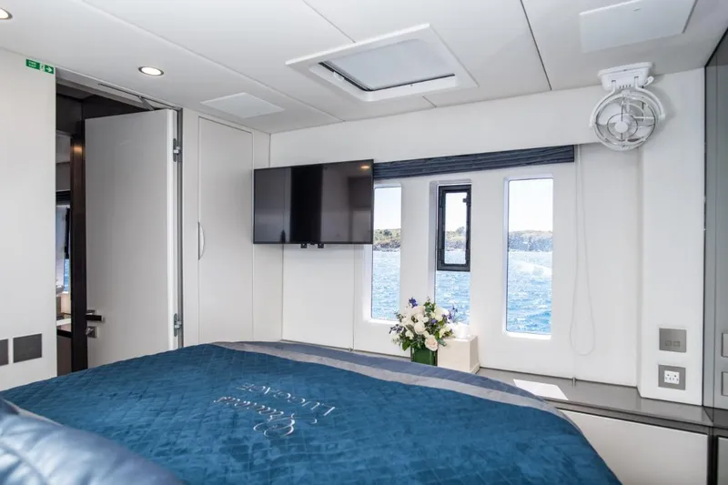 Gracious Yacht Photos Pics Luxurious Sunreef 60 yacht bedroom interior, featuring ocean view windows and modern amenities, 2021 model.