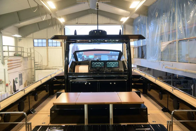 Windy Sr52 Yacht Photos Pics 2021 Windy SR52 yacht interior with modern dashboard and wooden table in a spacious workshop.