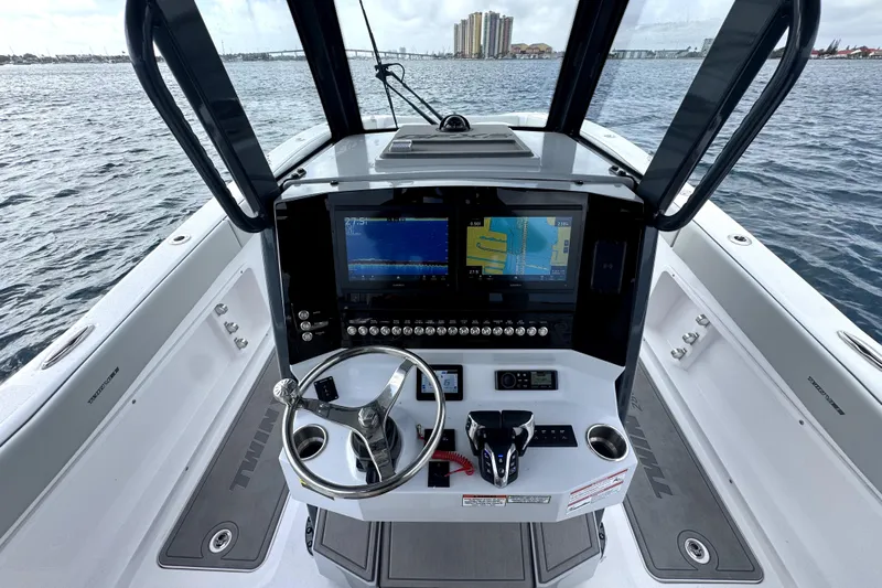  Yacht Photos Pics 2026 Twin Vee 280 GFX2 CC boat helm with advanced navigation displays on open water.