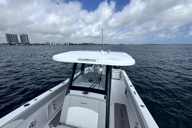  Yacht Photos Pics 2026 Twin Vee 280 GFX2 CC boat on open water with city skyline in background.