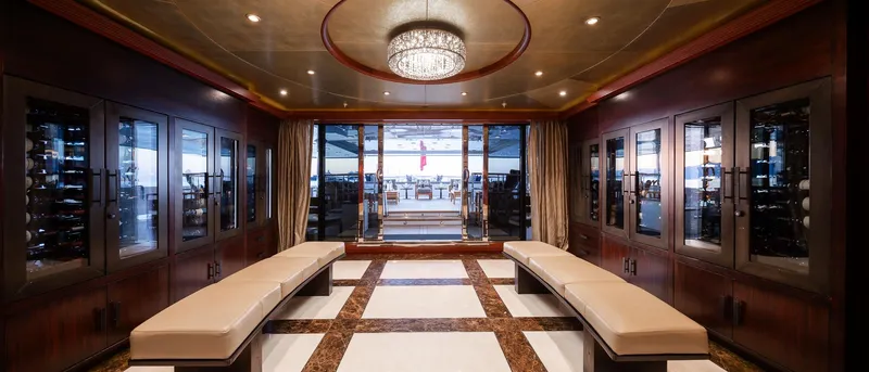 Skyfall Yacht Photos Pics Luxurious interior of 2010 Trinity Yachts motor yacht with elegant seating and wine storage.